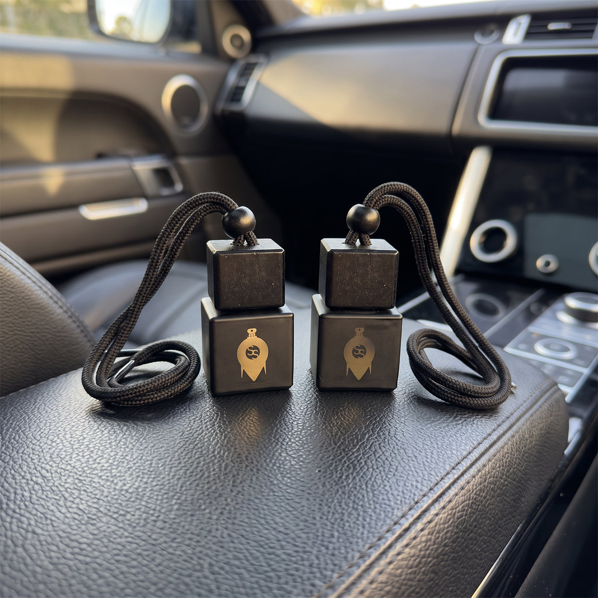 Two ScentStation diffusers hanging in a car